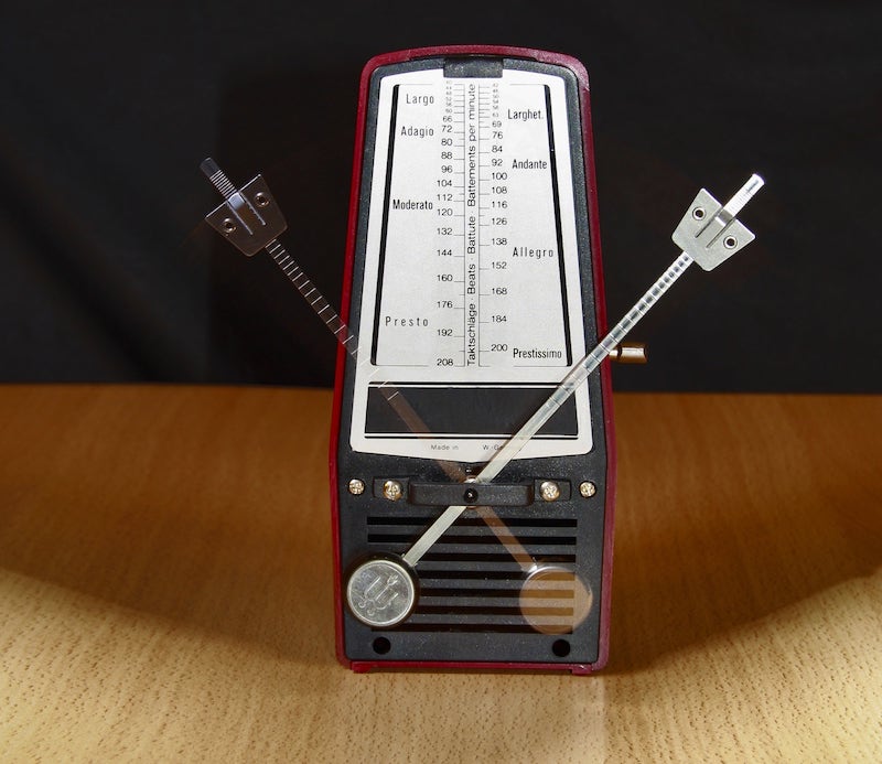 An old-fashioned metronome device.